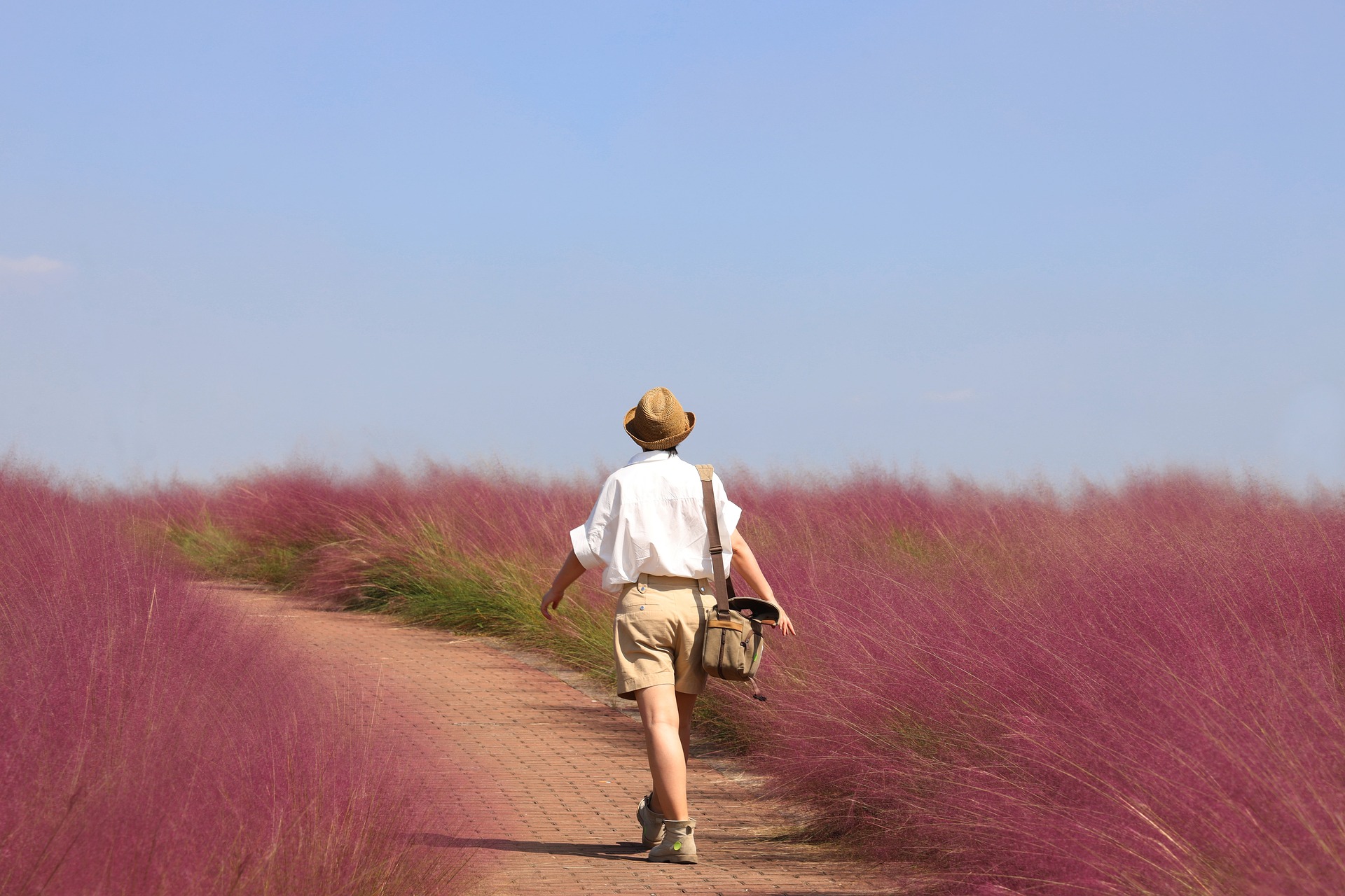 A person walking on a peaceful nature trail for self-care and relaxation.
