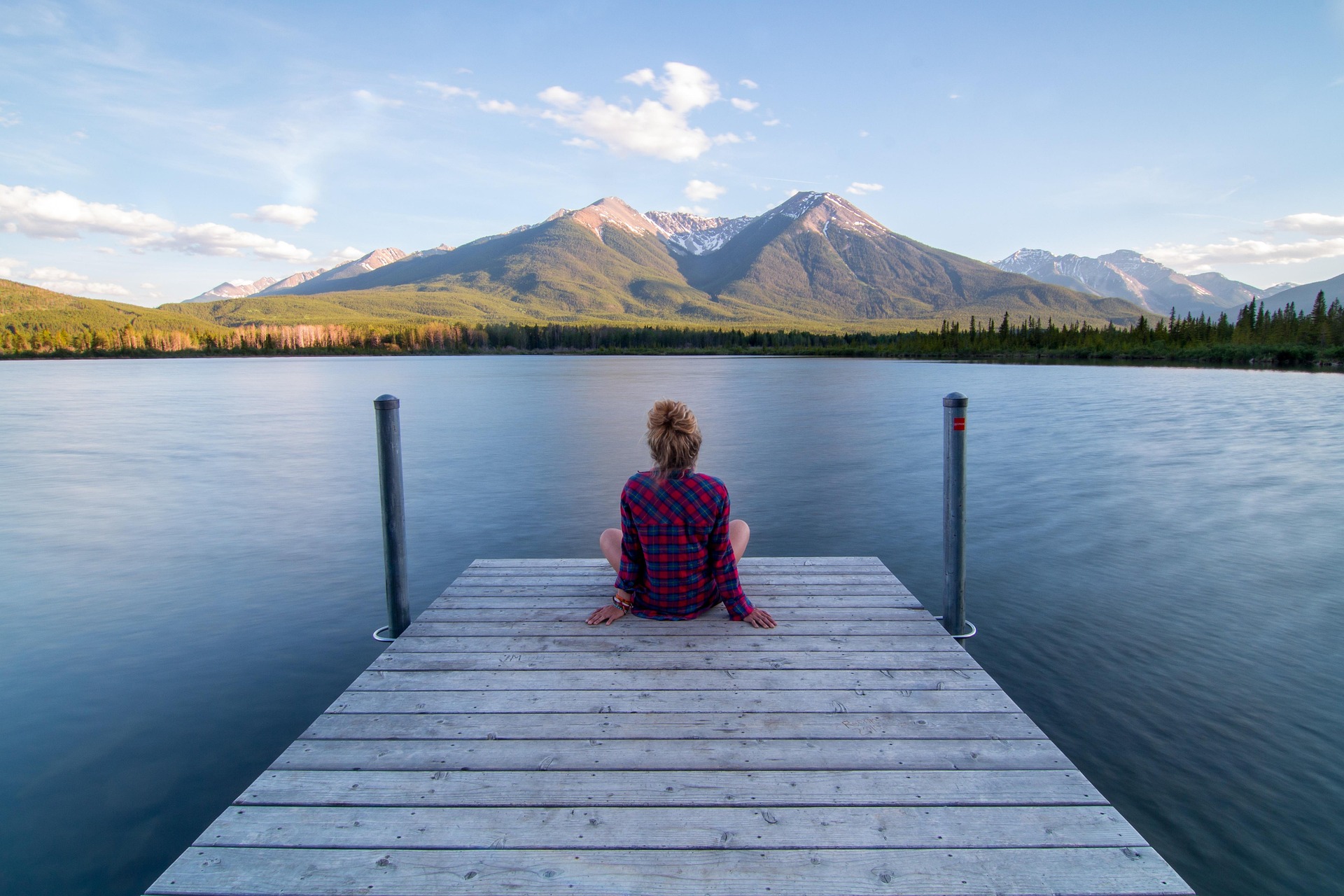 A person meditating in nature, finding peace through faith and reflection